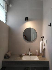 a bathroom with a sink and a mirror at Beseco Bed and Breakfast in Benaulim