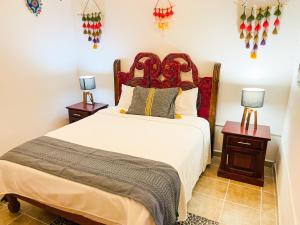 a bedroom with a large bed and two night stands at Casa Boho 1 in Sayulita