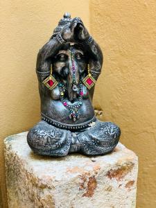 a statue of a woman sitting on a rock at Casa Boho 1 in Sayulita