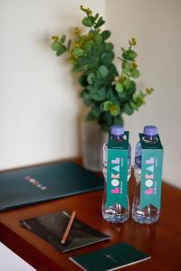 two bottles of water sitting on a wooden table at LOKAL x Skardu (City Center) in Skardu