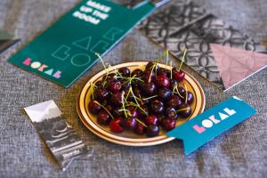 a plate of cherries sitting on a table at LOKAL x Skardu (City Center) in Skardu