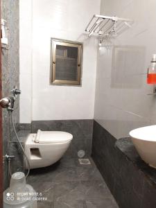 a bathroom with a toilet and a sink at U LIFE HOTEL in Mumbai