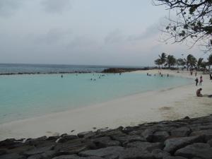 eine Gruppe von Menschen, die am Strand im Wasser schwimmen in der Unterkunft Off Day Inn in Male City