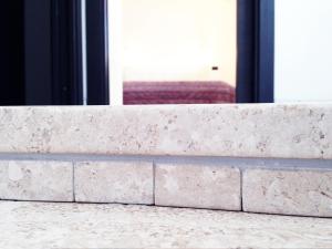 a stone wall with a view of a window at La Vallata B&B in Sardegna in Ghilarza