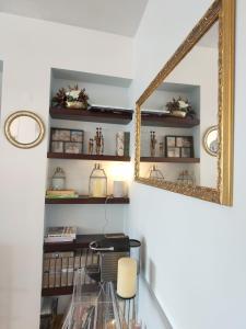 a dining room with a mirror and a glass table at Between River and Sea Porto Apartment in Porto