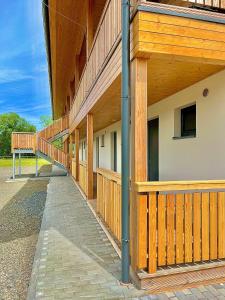 a building with a wooden fence next to a sidewalk at Sport HOTEL Bečva in Valašské Meziříčí