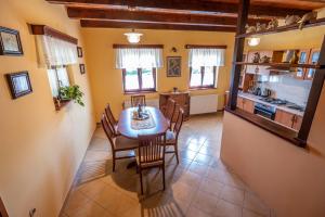 a kitchen and dining room with a table and chairs at Holiday Home Mare near River in Karlovac