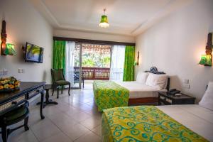 A bed or beds in a room at Bamburi Beach Hotel