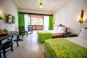 A bed or beds in a room at Bamburi Beach Hotel