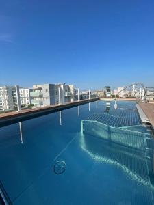 a swimming pool on the roof of a building at Almalux Jesolo Wellness & Spa 3 stelle superior in Lido di Jesolo