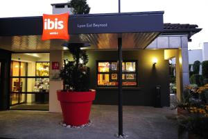 un frente de tienda con un cartel delante en ibis Lyon Est Beynost, en Beynost