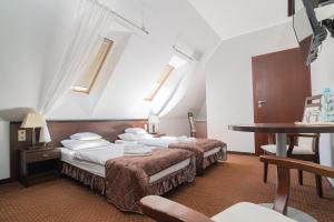 Posteľ alebo postele v izbe v ubytovaní Hotel Pod Filarami