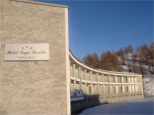 a building with a sign on the side of it at Hotel Lago Losetta in Sestriere