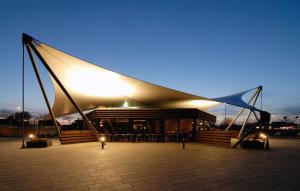 a lit up building with a large white tent at Hotel Østersø in Aabenraa