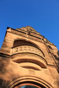 a tall building with a blue sky in the background at Hotel Deutscher Kaiser in Nürnberg