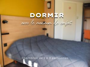 A bed or beds in a room at Premiere Classe Rodez