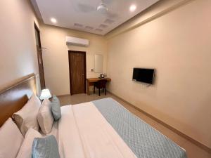 a hotel room with a bed and a tv at HOTEL TNCS - Couple Friendly Local IDs Accepted in Noida