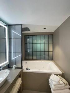 a bathroom with a bath tub and a sink at Les Neiges D'Antan in Breuil-Cervinia