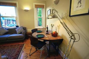 a living room with a table and a lamp at Tastefully Decorated 1-Bed with Free Parking - At Hem in Winchester