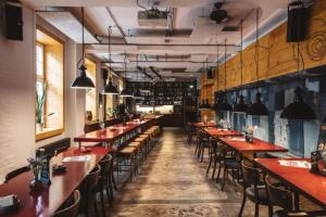 a row of tables and chairs in a restaurant at Superbude Hamburg St Pauli in Hamburg