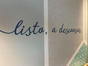 a sign for a bathroom with the words listico a designer at One Tapachula in Tapachula