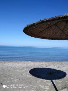 uma sombra de um guarda-sol na praia em Grecos apartment em Preveza