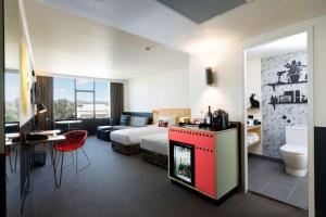 a hotel room with a bed and a flat screen tv at Atura Albury in Albury