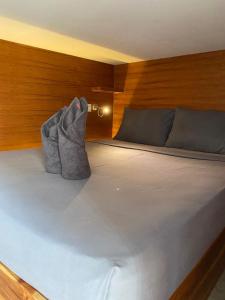 una cama con dos almohadas encima en Kaniu Capsule Hostel, en Kuta Lombok