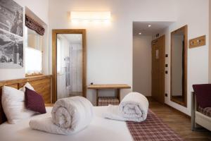 een slaapkamer met een bed met witte kussens erop bij Green Rose in Livigno