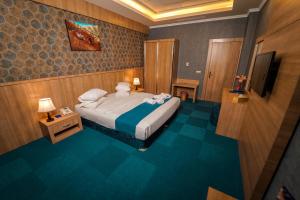 een slaapkamer met een bed met handdoeken erop bij Sipan Hotel in Erbil