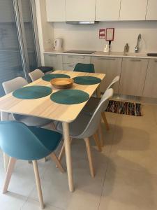 a wooden table and chairs in a kitchen at Apartamento Férias (Apartamento Norte) in Costa Nova