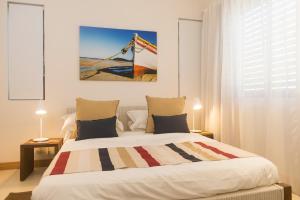 a bedroom with a bed with a flag on it at Cap Ouest by Horizon Holidays in Flic-en-Flac