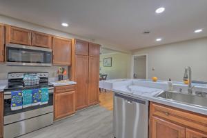 a kitchen with stainless steel appliances and wooden cabinets at Coastal Edgewater Home with Private Hot Tub! in Annapolis