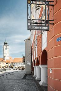 a sign on the side of a building on a street at Hotel Casa Luxemburg- Newly Renovated in Sibiu