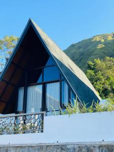 a house with a roof with windows on a hill at Bukit Tiga Lima Boutique Hotel in Sajang