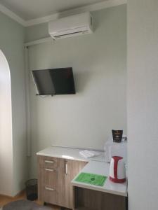 a kitchen with a counter with a toaster and a microwave at Апартаменти в Старому Місті Sweet House in Kamianets-Podilskyi