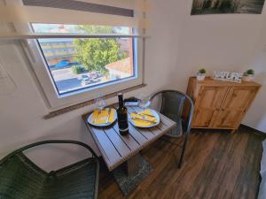 a table with glasses and a bottle of wine on it at Hostel BellaVista in Koper