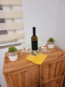 a bottle of wine sitting on top of a wooden cabinet at Hostel BellaVista in Koper