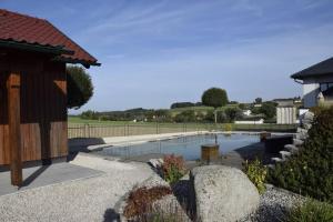 a swimming pool in a yard next to a house at Ruheoase in Wolfern, zw. Wien & Salzburg 