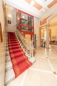 - un escalier dans un bâtiment doté d'un tapis rouge dans l'établissement Hotel Pallanza by LVG Hotel Collection, à Verbania