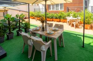 a table and chairs on a patio with green grass at Sevastopol apartments Varna in Varna City