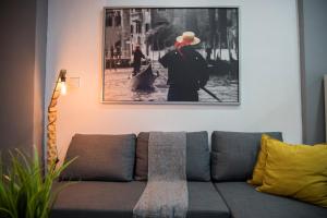 a living room with a couch with a picture on the wall at BILLYS HOUSE in Tríkala