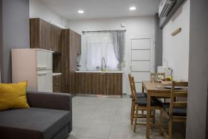 a living room with a couch and a table and a kitchen at BILLYS HOUSE in Tríkala