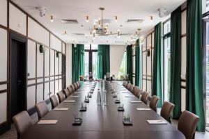 a long conference room with a long table and chairs at La Maison Palmier Abidjan, a Member of Design Hotels in Abidjan