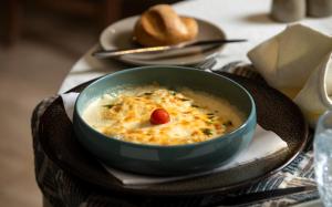 a bowl of soup on a plate on a table at Campanile El Mechtel Tunis in Tunis