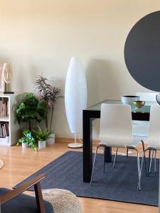 une salle à manger avec une table et des chaises blanches dans l'établissement Oporto beach apartment, à Matosinhos