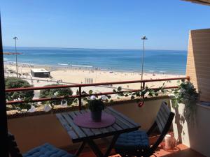 d'un balcon avec une table et une vue sur la plage. dans l'établissement Oporto beach apartment, à Matosinhos