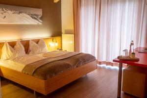 Un pat sau paturi într-o cameră la Hotel Auwirt Zentrum