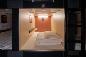 a small room with a bed inside of it at NINJA & GEISHA in Osaka