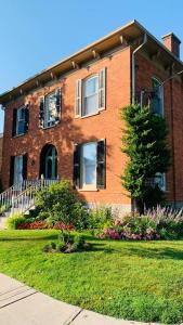 a brick house with a tree in front of it at The 1885 Suites in Picton